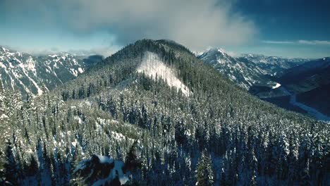 Snowy-Mountain-Range-Rising-Aerial-Reveal-Early-Winter