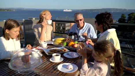 A-big-happy-family-has-dinner-on-the-open-terrace-on-the-roof-of-the-house.