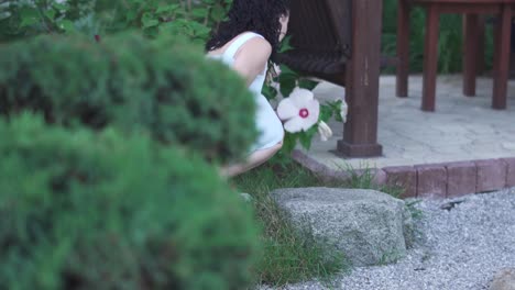 Beautiful-girl-is-sniffing-a-flower.