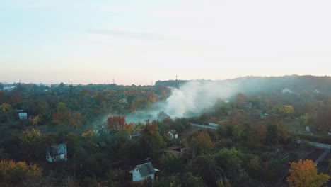 white-clouds-of-smoke-is-covering-the-countryside-as-a-result-of-fire-in-hot-summer-weather.