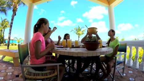 Caucasian-family-enjoying-lunch-outdoors-at-vacation-resort