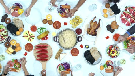 Top-view-of-dinner-on-table-together.-People-enjoy-eating-and-drinking-in-party.-Concept-of-festival,-birthday,-happy-new-year-and-christmas.-4k-resolution.