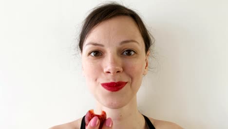 Portrait-of-woman-eating-strawberries.-Front-view.