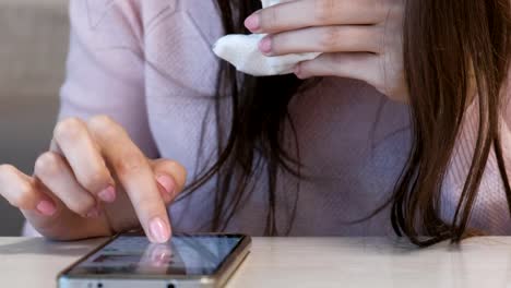 Mujer-irreconocible-comer-Shawarma-sentado-en-un-café-y-escribiendo-un-mensaje-en-el-teléfono-móvil.