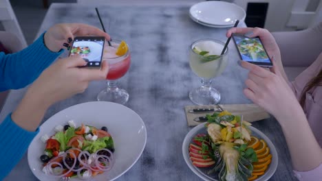 vegetarians-woman-Friends-using-smartphone-and-taking-photo-of-beautiful-food-for-social-media-during-healthy-breakfast-in-restaurant