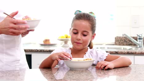 Mother-and-her-daughter-eating-cereals-together