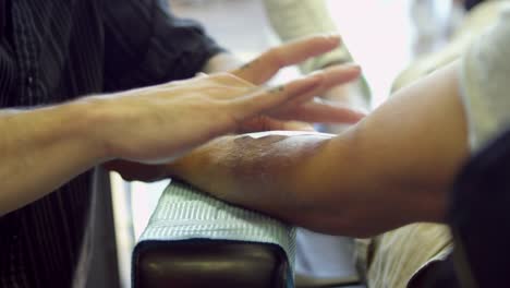 Close-Up-Of-Man-Having-Tattoo-In-Parlor