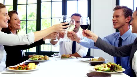 Business-people-toasting-and-having-lunch