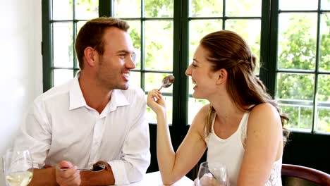 Couple-feeding-each-other-and-smiling