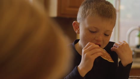 A-little-boy-eating-pancakes-with-his-hands