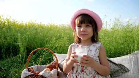 Pleasure-on-child's-face,-milk-advertising,-Healthy-food-for-children,-little-female-child-at-picnic-drinks,-dairy-products,-healthy-kid-drinks