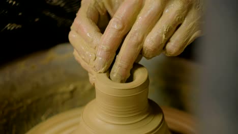 Professional-male-potter-working-in-workshop