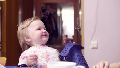 Little-baby-girl-eating-cheese-and-smiling