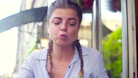 Portrait-of-young-woman-eating-cookie