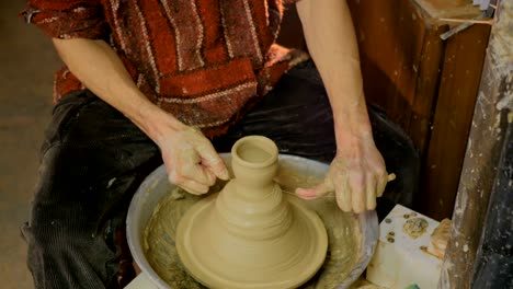 Professional-male-potter-working-in-workshop,-studio