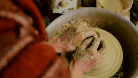 Professional-male-potter-working-in-workshop