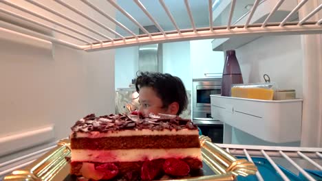 Hungry-boy-eating-cake-from-Fridge