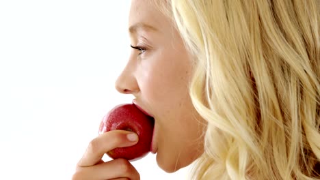 Close-up-of-beautiful-woman-eating-red-apple