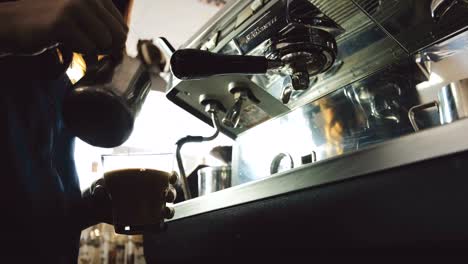 Barista-pouring-milk-into-espresso