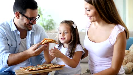 Glückliche-Familie-gemeinsam-Pizza-zu-Hause