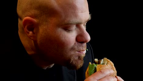 profile-of-bald--hungry-man-grabs-a-burger-voracious