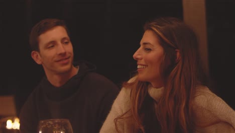 Close-up-shot-of-a-young-attractive-couple-sitting-at-a-patio-table