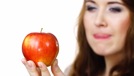 Woman-holds-red-apple,-focus-on-fruit