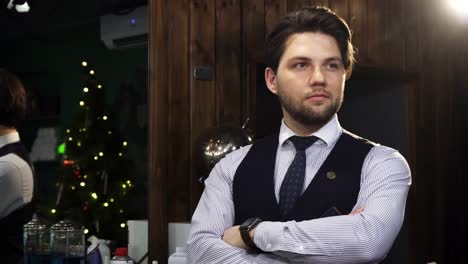 Professional-barber-posing-at-his-barbershop-smilign-joyfully