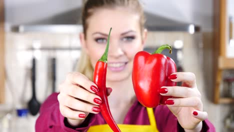 Woman-choosing-between-chilli-and-bell-pepper