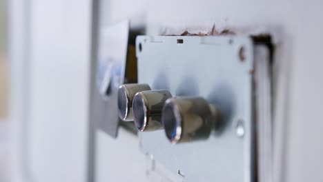 Close-Up-Of-Electric-Light-Switches-And-Dimmers-Being-Fitted