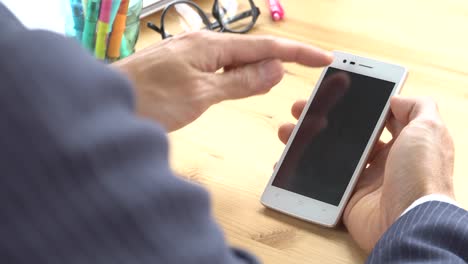 Businessman-in-Suit-Slide-Zoom-Touch-Smartphone-in-Home-Office