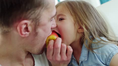 Cute-Girl-and-Father-Biting-Apple