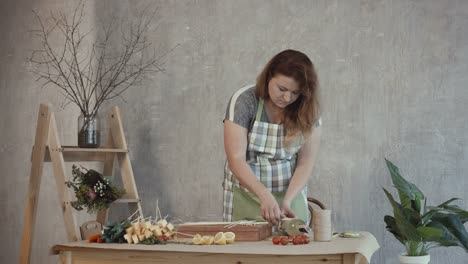 Redhead-woman-arranging-edible-bouquet-arrangement