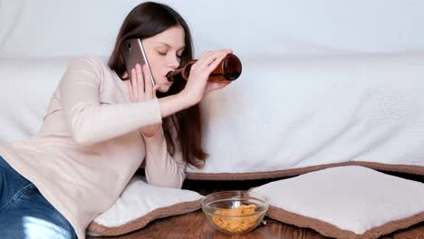 Conversación-difícil-a-las-mujeres-en-el-teléfono.-Ella-come-patatas-fritas-y-bebe-cerveza.