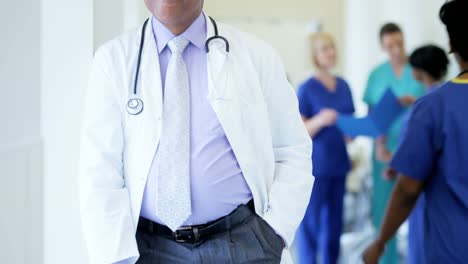 Portrait-of-confident-African-American-male-senior-staff-in-medical-centre