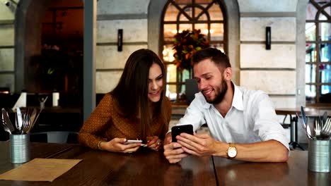 Cheerful-multiracial-friends-taking-selfie-in-pizzeria