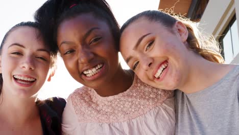 Portrait-Of-Female-High-School-Student-Friends-Outside-College-Buildings