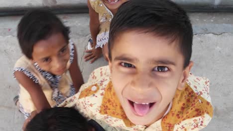 Kids-play,-having-fun-and-sticking-their-tongues-out-for-a-selfies-on-a-mobile-phone-camera,-India