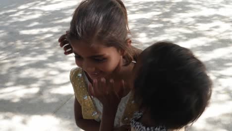 Sisters-bonding-together-playing-jumping-and-point-at-the-sky-to-camera