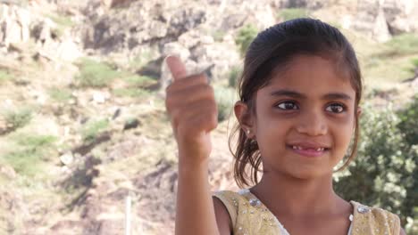 Thumbs-up-from-a-cute-little-Indian-girl-with-missing-teeth