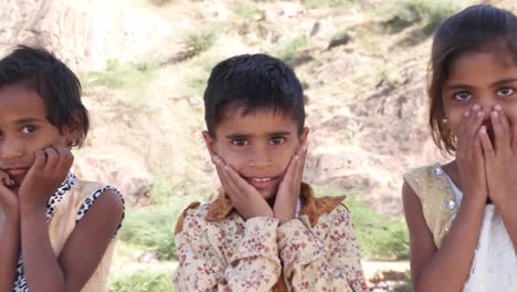 Indian-children-portrait-happy-and-excited,-playing-and-making-merry-in-sand-area-in-Rajasthan-state-of-India