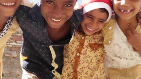 MS-Kids-with-Santa-hats-having-fun-and-bending-down-towards-the-camera