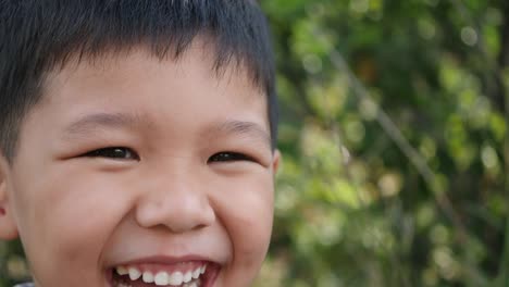 Close-up-little-boy-laughing-and-smile-after-hearing-joke-story