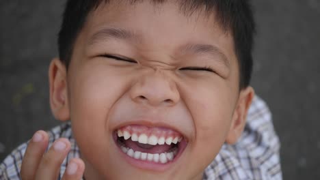 Close-up-little-boy-laughing-and-smile-after-hearing-joke-story