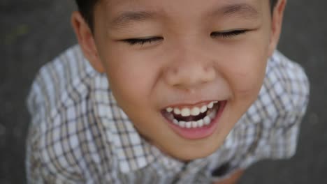 Close-up-little-boy-laughing-and-smile-after-hearing-joke-story