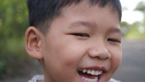 Close-up-little-boy-laughing-and-smile-after-hearing-joke-story