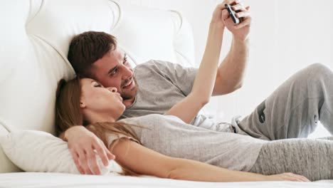 Pareja-feliz-tomando-Selfie-en-la-cama