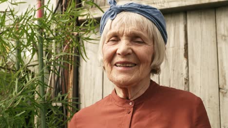 Happy-Senior-Woman-Smiling-for-Camera-in-her-Garden