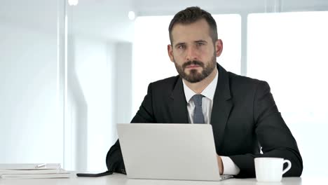 Portrait-of-Serious-Businessman-Looking-at-Camera