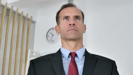 Portrait-of-Serious-Middle-Aged-Businessman-in-Office